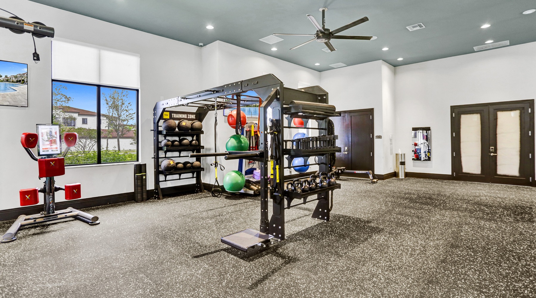 Welcome to MILA Apartments fitness center with rows of treadmills and modern style flooring