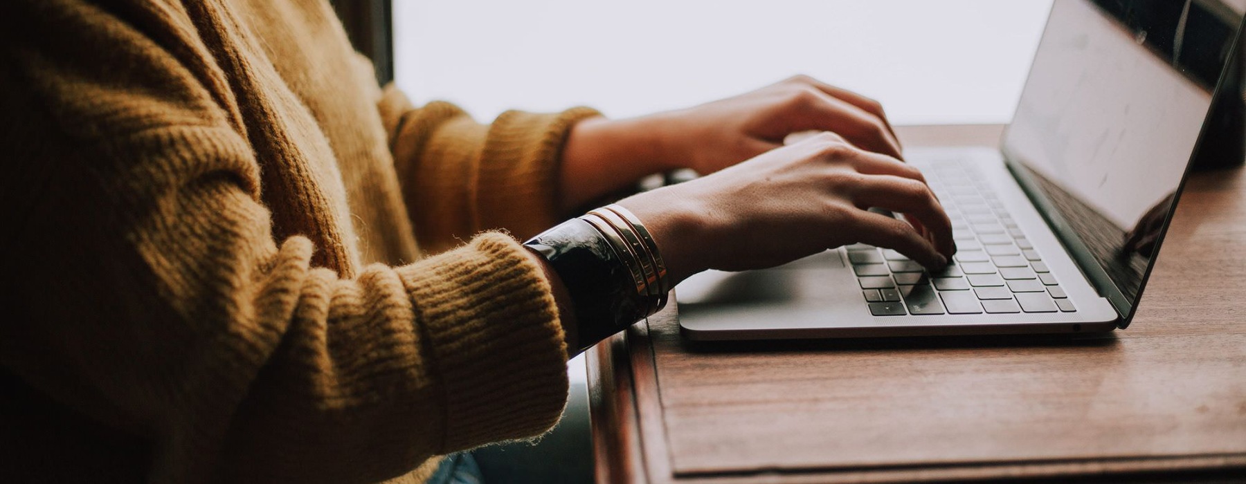 woman typing on laptop