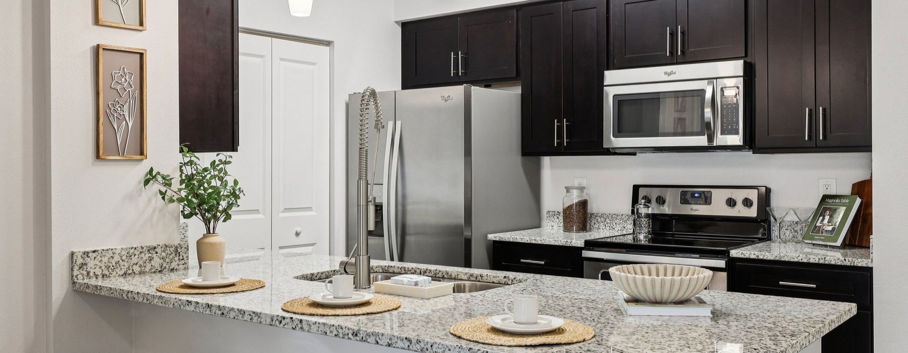 kitchen with black cabinets and refrigerator